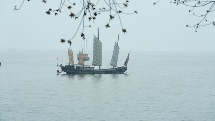 The lake landscapes with the old wooden ships on it in China
