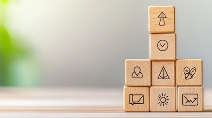 A pyramid of wooden blocks features various icons representing growth, communication, and strategy against a blurred background.