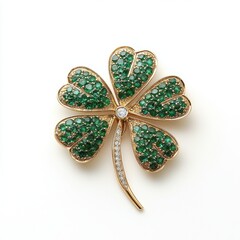 A decorative brooch shaped like a four-leaf clover, embellished with green stones and a central diamond, symbolizing luck and elegance.
