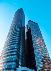 Obraz premium Low angle view of modern glass skyscrapers against a blue sky skyscraper city building skyscraper downtown business architecture cityscape
