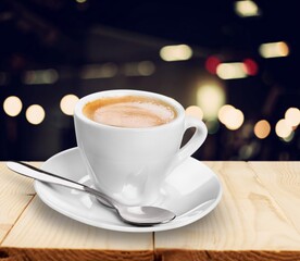 Tasty hot coffee in white cup on table