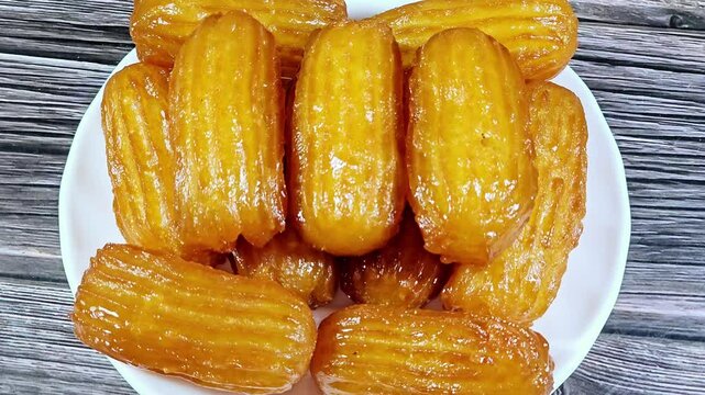Balah el Sham or Egyptian Choux Pastry, very popular Ramadan month dessert in Egypt and middle east, crispy and tender choux pastry deeply fried and coated in sweet simple sugar syrup, served cold