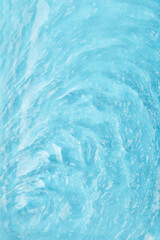 Vertical. Water background. Turquoise water flows with soft ripples. Gentle waves and translucence evoke tranquility and relaxation. Concept of freshness, natural beauty and environmental harmony