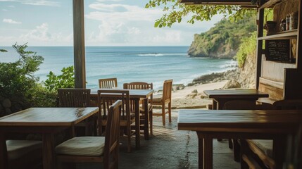Obraz premium A casual yet elegant beach caf with wooden tables and cushioned chairs, with a stunning view of the ocean horizon.