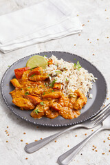 Salsify Curry with Rice on a black plate