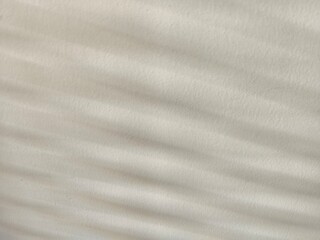 white silk background Light passes through the blinds and hits the cream-white wall, creating patterns and shadows.