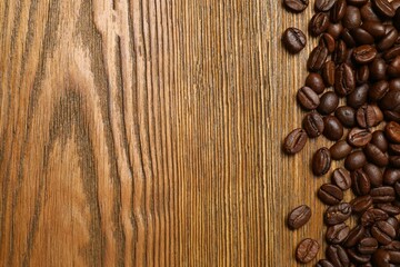 Fresh coffee beans on wooden background