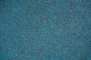Turquoise textured floor made of small rocks. A unique and interesting background for creative applications.