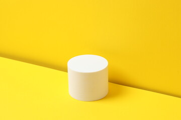 White podium on yellow background