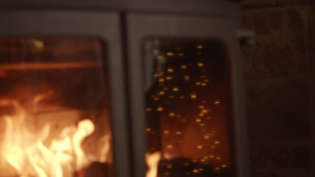 A fireplace with a lot of glowing embers and a lot of smoke. The fire is very hot and the smoke is thick