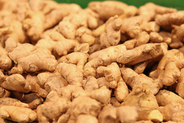 Ginger close-up in the store. Ginger root in the grocery section. Ginger in a plastic box at the food market. Tasty and healthy food. A product for maintaining immunity