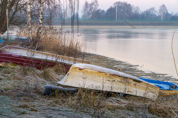 abandoned fishing boats on the beach after fishing season. abandoned boat harbor on a winter...