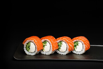 Delicious Fresh Salmon Sushi Rolls Presenting Exquisitely on a Black Background