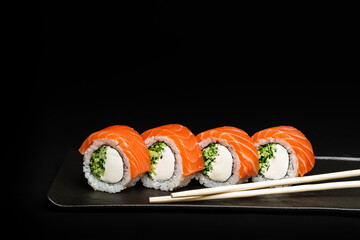 Delicious Fresh Salmon Sushi Rolls Presenting Exquisitely on a Black Background