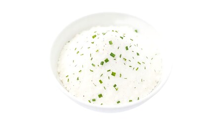 White powder seasoning with green herbs in bowl