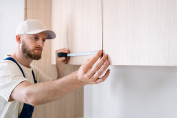 Renovation of kitchen cabinets by a professional handyman in a modern apartment