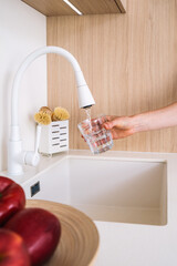 Modern kitchen sink with minimalist design and running water for daily use