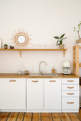 Modern boho kitchen interior with minimalist decor and wooden accents