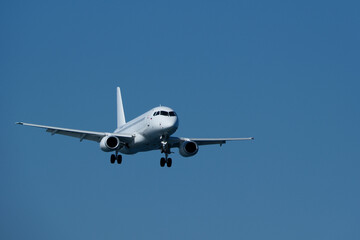 Airplane in the blue sky. Plane ready to land at the airport
