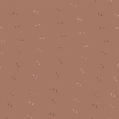 Bird footprints on a toffee brown background 