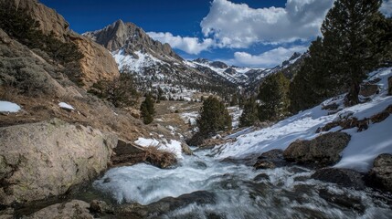 Mountain Stream Flows Through Snowy Valley Landscape