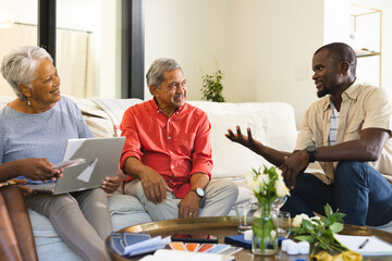 Diverse family sharing stories and laughter together at home across three generations