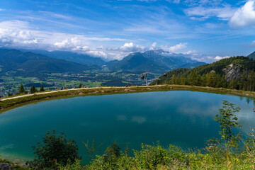 Obraz premium Stunning panorama view of the Bavarian alps with reflection of sky and cloud in small lake near Jenner cable car middle station, Schoenau am Koenigssee, Bavaria, Germany