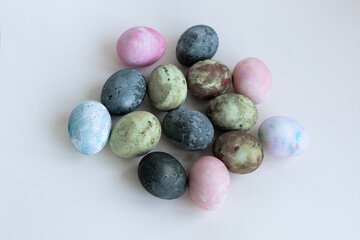 four Easter eggs painted in green-brown colors, karkade tea, soft pastel colors, background