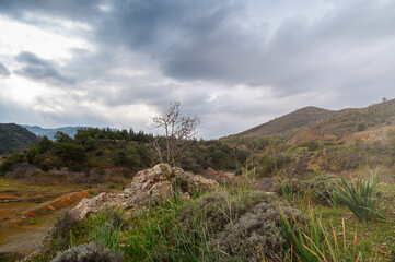 Mysterious landscape under dramatic clouds in a serene mountain valley