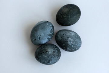 four Easter eggs painted with karkade tea