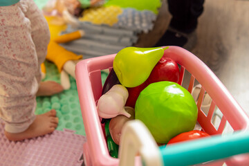 Children's set of toy vegetables in a cart. Educational toys