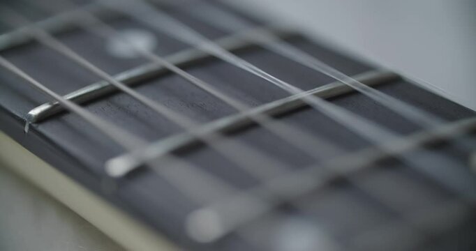 Detailed view of guitar fingerboard that beautifully showcases its frets and strings in intricate detail