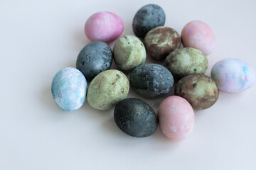 four Easter eggs painted in green-brown colors, karkade tea, soft pastel colors