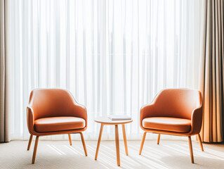 A cozy seating area featuring two stylish armchairs and a small table, illuminated by natural light through sheer curtains.