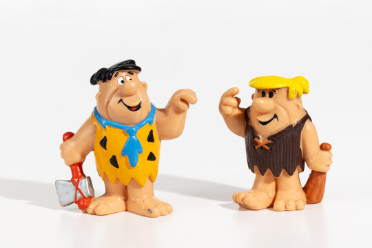 Fred Flintstone and Barney miniature figurines are having a conversation