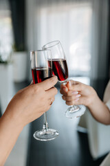Close-up photo of a beautiful girl with a red cocktail in her hands