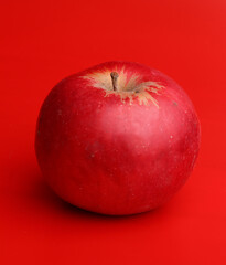 red apple on a red background