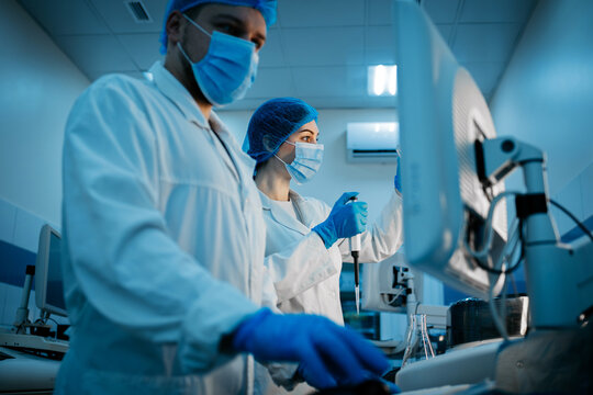 A scientist works with high-tech equipment in a modern laboratory, analyzing biological material and conducting experiments. Concept research of biological samples using cutting-edge technology.