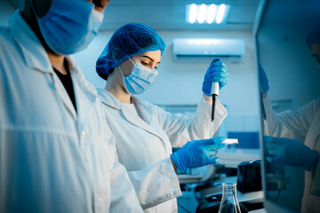 A scientist works with high-tech equipment in a modern laboratory, analyzing biological material...