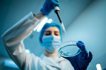 A specialist in a laboratory holds a liquid and analyzes it. The concept: utilizing high-tech methods for accurate analysis and scientific research.