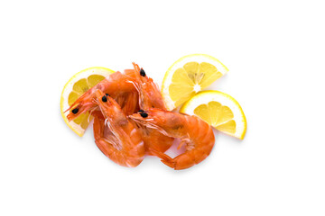 Three boiled shrimp with bright orange shells, laid out on a white background along with fresh lemon wedges.