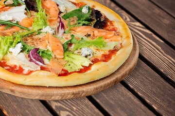 Sliced tasty fresh pizza dish on desk