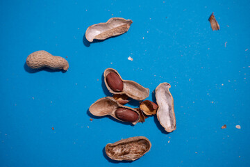 Natural whole peanuts in a shell on a blue background.Peel the peanut from the shell.Top view.