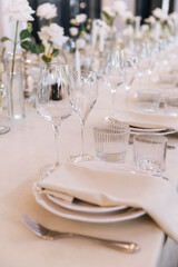 Decorated table with fresh flowers and serving with cake. Celebrating a party in a restaurant