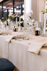 Decorated table with fresh flowers and serving with cake. Celebrating a party in a restaurant