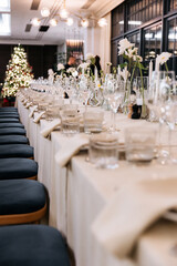 Decorated table with fresh flowers and serving with cake. Celebrating a party in a restaurant