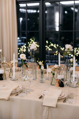 Decorated table with fresh flowers and serving with cake. Celebrating a party in a restaurant