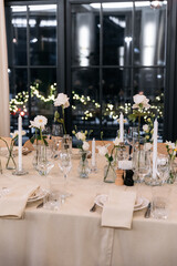 Decorated table with fresh flowers and serving with cake. Celebrating a party in a restaurant