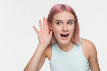 Close up of young curious nosy fun smiling hipster woman 20s wearing casual basic crop top try to...