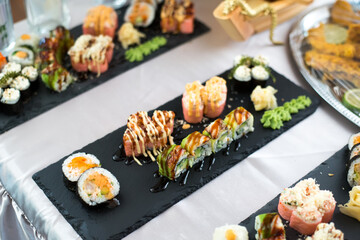 Close up view of assorted sushi - japanese sushi food. Maki and rolls with tuna, salmon, shrimp, crab and avocado.